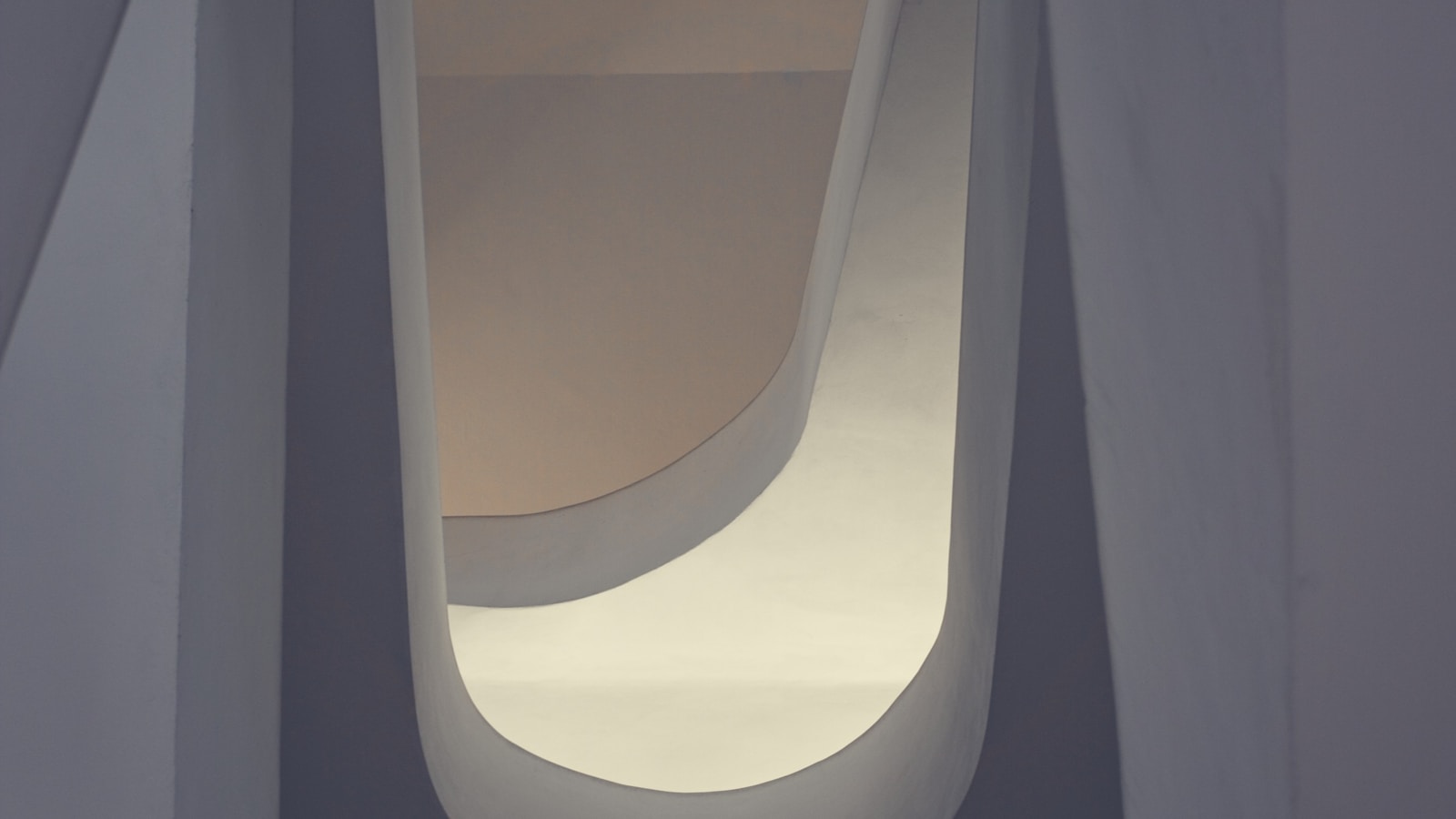 Curved architectural forms illuminated by soft light